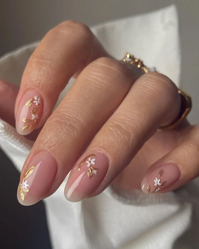 Floral-Gold-Detailing-on-Nude-Nails.webp