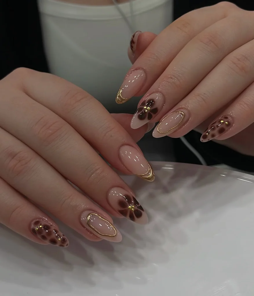 Nude-Nails-with-Floral-Gold-Detailing.webp