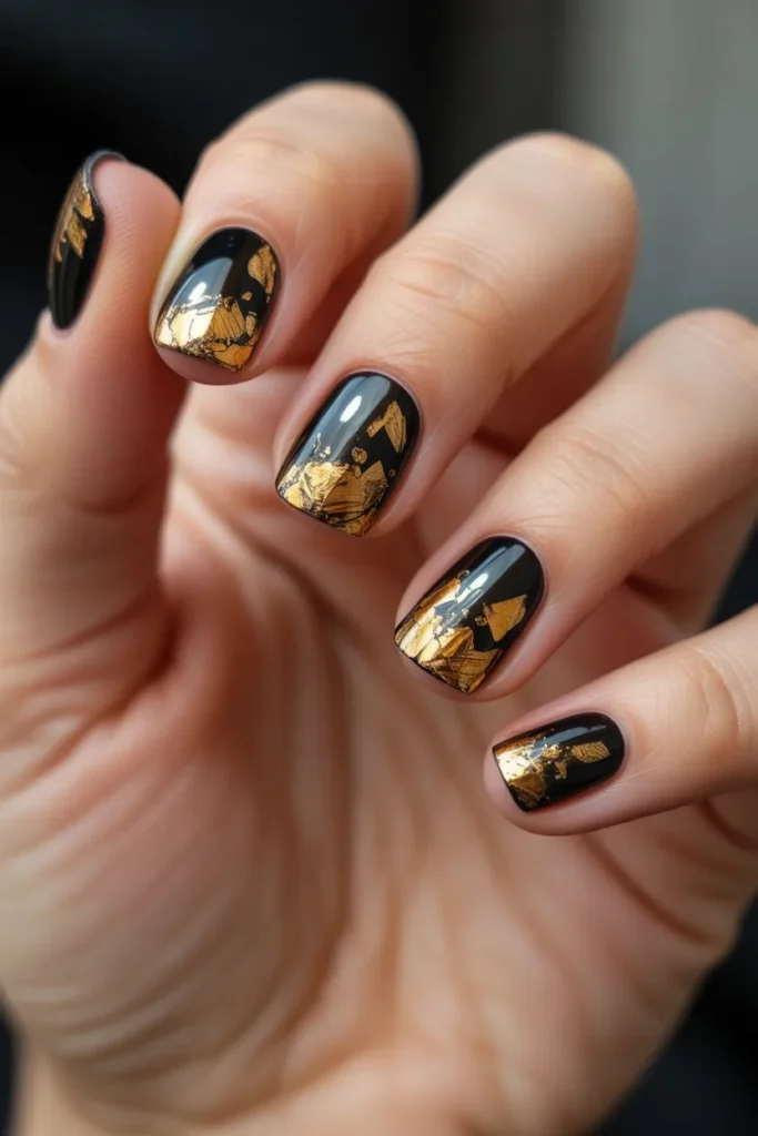 Black Nails with Gold Foil Accents